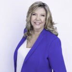 A waist-up photo of Tennessee Rep. Gloria Johnson wearing a blue blazer in front of a white background.